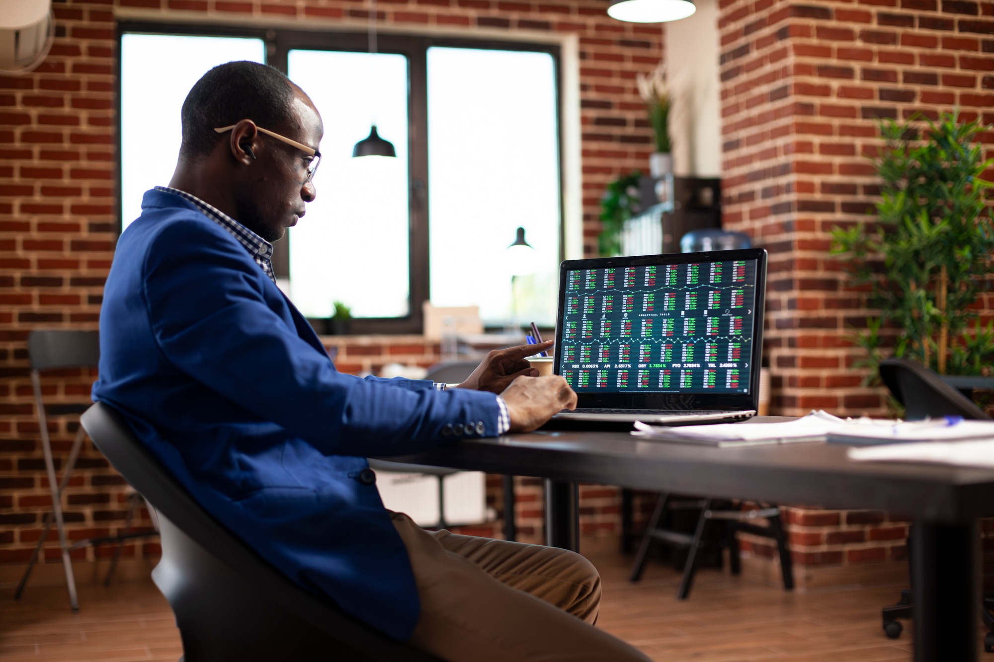 Businessman reviewing trends on laptop